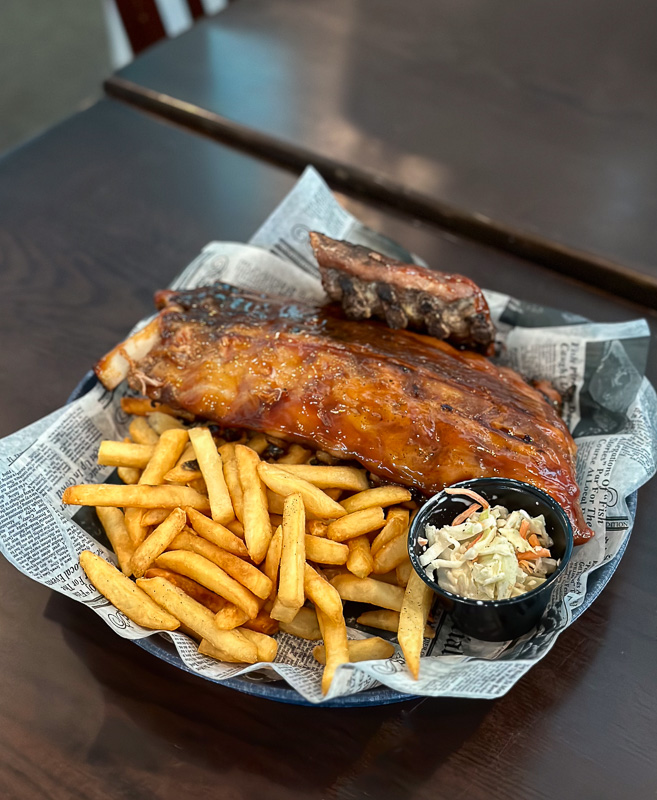 Rum Bay Ribs with Award Winning Swamp Sauce, crispy fries, and Island Sweet Slaw in Sarasota, FL