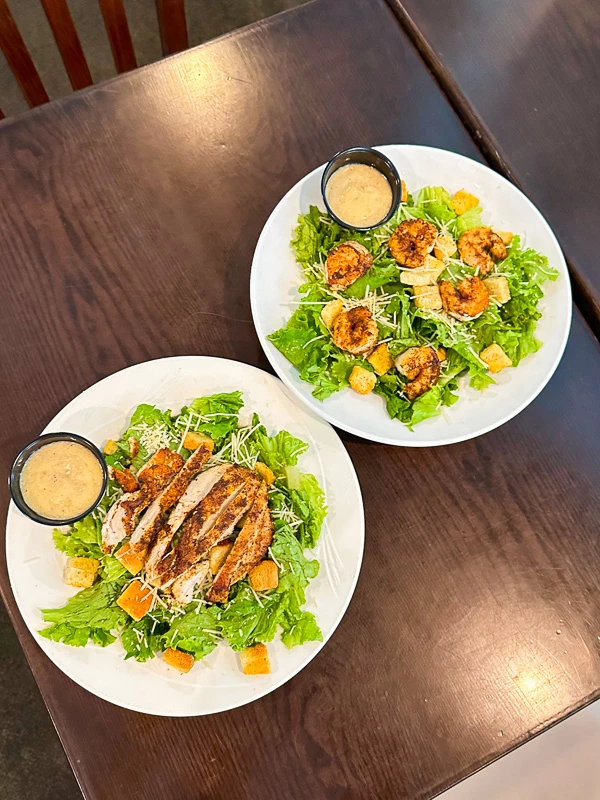 Caesar Salad with romaine, parmesan, croutons, grilled shrimp, and grilled chicken on a private island in Sarasota, FL